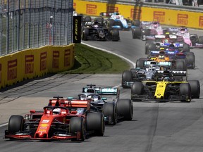 Scuderia Ferrari Mission Winnow driver Sebastian Vettel (5) of Germany leads the crowd in to the first turn during the Canadian Grand Prix at the Circuit Gilles Villeneuve in Montreal, on Sunday, June 9, 2019.