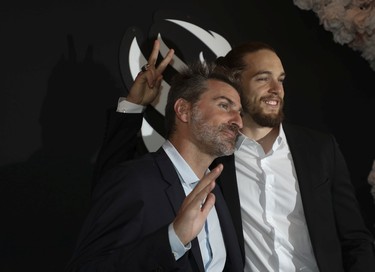Montreal Alouettes player Marc-Antoine Dequoy (right), with comedian Jean-Thomas Jobin, joke around for photographers at the Grand Prix Party at the Ritz-Carlton Hotel on June 17, 2022.