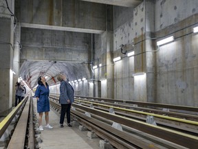 Mayor Valérie Plante, left, and Chantal Rouleau, Quebec minister of responsible for the Montreal region, walk through one of the tunnels at the STM’s new underground garage.