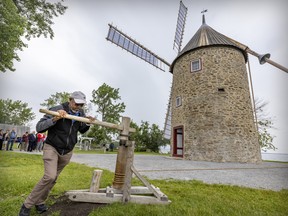Oscar Santana pushes a winch as he works with Cristian Perez to turn the blades into the wind during the inauguration of the restored windmill in the Parc historique de la Pointe-du-Moulin in Notre-Dame-de-L’Ile Perrot. The masonry and excavation work took place between 2018 and 2019, followed by the restoration of the mill components between 2020 and 2021. The public is invited to come discover its workings as part of Mill Day on July 3. During this day, access to the site will be free. The Société de développement des entreprises culturelles (SODEC) has announced that it will undertake a new project to restore the adjacent miller's house. For more information, visit pointedumoulin.com.