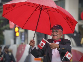 Dr. Roopnarine Singh, founder of the Montreal Canada Day parade in 1978, rides in the back of a convertible on Ste-Catherine St. during the 2015 version of the parade in Montreal Wednesday July 01, 2015. Dr. Singh organized the parade for 26 years.