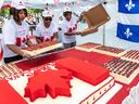 Montrealers of all nationalities took part in the Canada Day Parade in Montreal on July 1, 2019, the last time it was held.  Volunteers Christine Busby, Dorothy Champagne and Jean Harry grabbed and guarded the birthday cake that was distributed to the public at the end of the parade on Place du Canada. 
