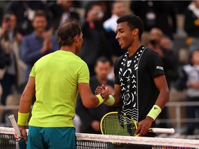 Rafael Nadal of Spain shakes hands with Felix Auger-Aliassime of Canada following the Men's Singles Fourth Round match on Day 8 of The 2022 French Open at Roland Garros on May 29, 2022 in Paris, France.