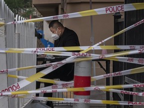 A security guard behind police tape controls the entrance area near the Heaven Supermarket and other nightclubs, that is at the center of the city's latest COVID-19 outbreak, on June 13, 2022 in Beijing, China.