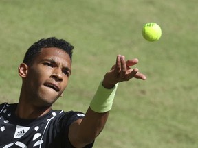 Felix Auger-Aliassime from Canada serves the ball to Marcos Giron from United States during their match at the ATP tennis tournament in Halle, Germany, Tuesday, June 14, 2022. Auger-Aliassime moved on to the second round of the Halle Open tennis tournament with a 6-3, 5-7, 6-3 win over Giron.