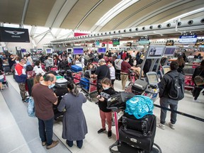 Travellers wait in the queue at Toronto Pearson Airport's Terminal 1, Thursday May 9, 2022.