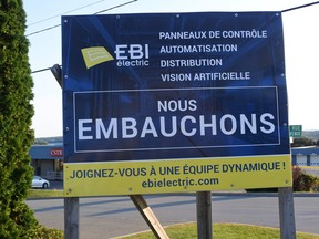 "Hiring" signs are seen outside most businesses in the city of Saint-Georges.