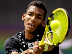 Montrealer Félix Auger-Aliassime plays a backhand return against Netherland's Tim Van Rijthoven during their semifinal men's singles match at the Libema Open tennis tournament in Rosmalen, Netherlands, on Saturday, June 11, 2022.