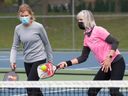 Susan Sowerby watches teammate Debbie Lunan return the ball during a pickleball game at Heritage Park in Kirkland on May 7, 2021. 