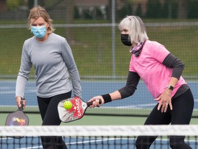 Susan Sowerby watches teammate Debbie Lunan return the wife ball during a game of pickleball at Heritage Park in Kirkland May 7, 2021.
