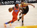 April 13, 2021;  Salt Lake City, Utah, United States;  Oklahoma City Thunder forward Luguentz Dort (5) drives against Utah Jazz forward Georges Niang (31) in the first quarter at the Vivint Smart Home Arena. 