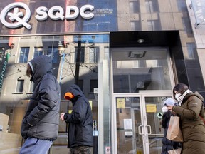 People walk by an SQDC (Société québécoise du cannabis) store in Montreal on Jan. 15, 2022.