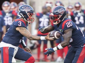 Montreal Alouettes quarterback Vernon Adams Jr., (3) hands off to running back Jeshrun Antwi during first half CFL pre-season football action against the Ottawa Redblacks in Montreal, Friday, June, 3, 2022.