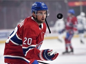 Canadiens defenceman Chris Wideman flips a puck to a young fan during the warmup period before a game against the Toronto Maple Leafs at the Bell Centre on Sept. 27, 2021.