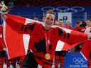Marie-Philip Poulin celebrates with her gold medal during the medal ceremony in Beijing. 