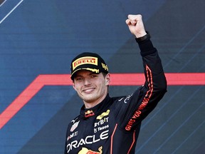 Red Bull's Max Verstappen celebrates on the podium after winning the Azerbaijan Grand Prix on June 12, 2022