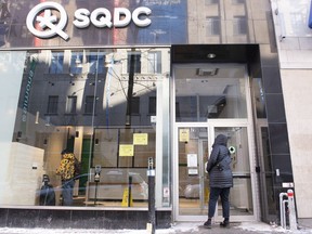 A person walks into an SQDC (Societe quebecoise du cannabis) store in Montreal, Saturday, Jan. 15, 2022. Employees of the Quebec cannabis corporation are staging a one-day walkout at about 15 branches.