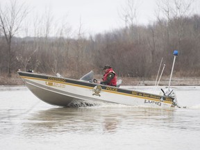 A member of the SQ patrols a river next to the town of Rigaud Sunday, April 21, 2019.