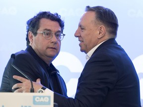 Premier François Legault embraces Bernard Drainville, one of two high-profile sovereignists recruited by the CAQ in recent days to run in the fall general election.