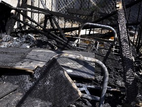 A bed frame and mattress are all that remain where unhoused brothers Frank and Thomas once lived, in this small camp, which burned under what the brothers think are questionable circumstances.