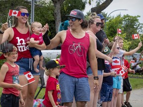 Tamara Hansen and Antoine Marchand, with daughter Olivia and nephews Émile and Alexandre Marchand, watch the Canada Day parade Friday in Greenfield Park.