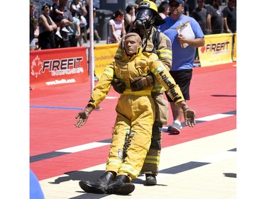 Pierre-Yves Lebeau of the Bedford fire dept drags a 175 pound mannequin as he easily wins his event in the Canadian Firefit Championships and picnic day, in Montreal, on Saturday, July 2, 2022.