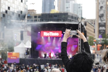 A fan snaps a picture at jazz fest's free outdoor show in Montreal on Tuesday, July 5, 2022.