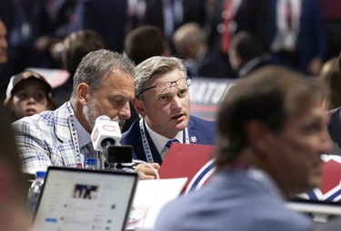 Members of the Montreal Canadiens follow the choices announced as they wait for their second pick during the 1st round of the NHL Draft in Montreal on Thursday, July 7, 2022.