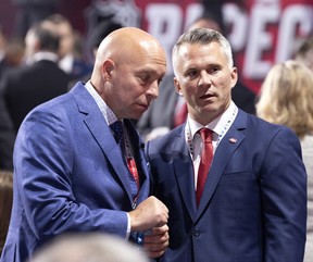 Montreal Canadiens GM Kent Hughes speaks with head coach Martin St. Louis, right, during the NHL Draft in Montreal on Thursday, July 7, 2022.