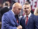 Montreal Canadiens general manager Kent Hughes speaks with head coach Martin St. Louis, right, during the NHL draft in Montreal on July 7, 2022.
