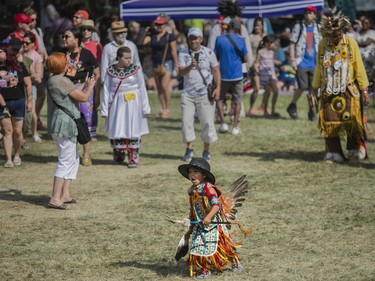 Lolik Wabanonik from Lac Simon and others, including audience members, take part in an inter-tribal dance at the 30th edition of the Echoes of a Proud Nation Pow-Wow in Kahnawake on Sunday, July 10, 2022.