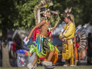 Mahgoosh Commonda, from the Kitigan Zibi Algonquin First Nation runs back to see his family after being awarded first prize for the boys' grass dancing competition at the 30th edition of the Echoes of a Proud Nation Pow-Wow in Kahnawake on Sunday, July 10, 2022.