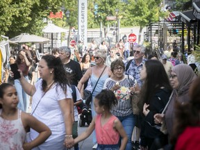 Tourists crowd Place Jacques-Cartier in Old Montreal on July 11, 2022.