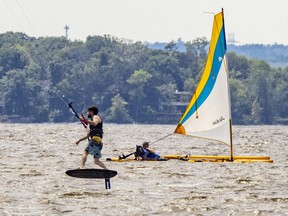 A kite surfer shares Lake of Two Mountains with a sailor off L'Anse-a-L'orme in Pierrefonds on Wednesday.