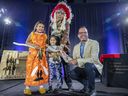 Denis Gros-Louis, right, director general of the First Nations Education Council, presents the wampum and a talking stick to Régis Penosway, chief of the Kitcisakik First Nation, and his daughters Deanna, left, and Aimé during a ceremony in Kahnawake marking the funding agreement between the federal government and 22 First Nations in Quebec.