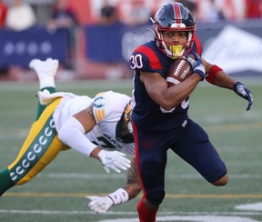 Montreal Alouettes's Chandler Worthy (30) pulls away from Edmonton Elks's Tre Watson (7) during first-half CFL action in Montreal on Thursday July 14, 2022.