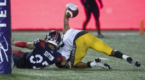 Edmonton Elks's Kenny Lawler (89) raises the ball in the air as after scoring the winning touchdown on Montreal Alouettes's Wesley Sutton (37) during second-half CFL action in Montreal on Thursday, July 14, 2022.