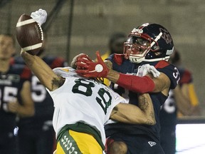 Alouettes' Wesley Sutton (37) gets pass interference on Edmonton Elks's Kenny Lawler (89) during second-half CFL action in Montreal on Thursday July 14, 2022.