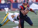 Chandler Worthy of the Montreal Alouettes walks away from Tre Watson of the Edmonton Elks during the first half in Montreal on July 14, 2022.