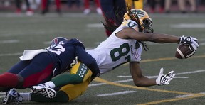 Edmonton Elks's Derel Walker (87) is brought down by Montreal Alouettes's Rodney Randle Jr. (32) during first-half CFL action in Montreal on Thursday, July 14, 2022.