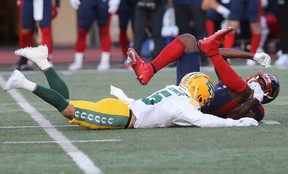 Montreal Alouettes's Tyson Philpot (81) is brought to the ground by Edmonton Elks's Malik Sonnier (5) during first-half CFL action in Montreal on Thursday, July 14, 2022.