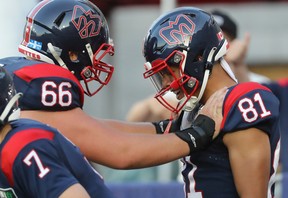 Montreal Alouettes's Tyson Philpot (81) celebrates his touchdown with teammate David Brown (66) during first-half CFL action in Montreal on Thursday, July 14, 2022.