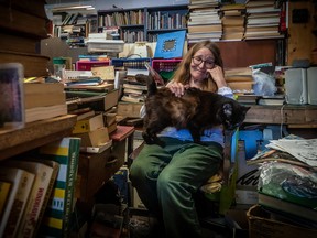 Livres Bronx, a second-hand bookstore — and kind of landmark for LaSalle residents — will close on July 21 after 25 years in business. Owner Robin Finesmith and cat Rufus in her LaSalle store on Sunday July 17, 2022.