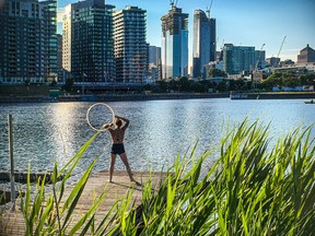 Laure-Line Caouette works out with a hoop on a dock at the Peel Basin in Montreal July 16, 2022.