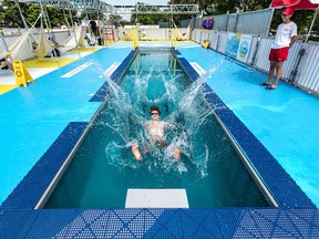Lifeguard Felix Poliseno makes a splash on Wednesday in the city's new "Piscinette" project — a small, saltwater pool built in a shipping container to help residents living in heat islands in and around Montreal.