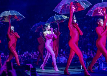 Dua Lipa's dancers carry umbrellas during her performance at the Bell Centre in Montreal on Monda,y July 25, 2022.