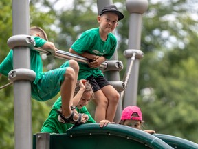 Camp Cosmos kids line up on the slide in Westmount Park July 21, 2022.