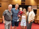 New Canadiens defenseman Mike Matheson holds his son Hudson in his arms while posing for a photo with his parents, Rod and Margaret, and his wife, Emily, in the Canadiens locker room at the Bell Centre.