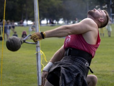 A competitor takes part in the weight over bar competition with the bar at 15 feet, during the Montreal Highland games in Montreal on Sunday, July 31, 2022.
