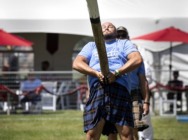 Competitors take part in the Caber Toss during the Montreal Highland games in Montreal on Sunday, July 31, 2022.